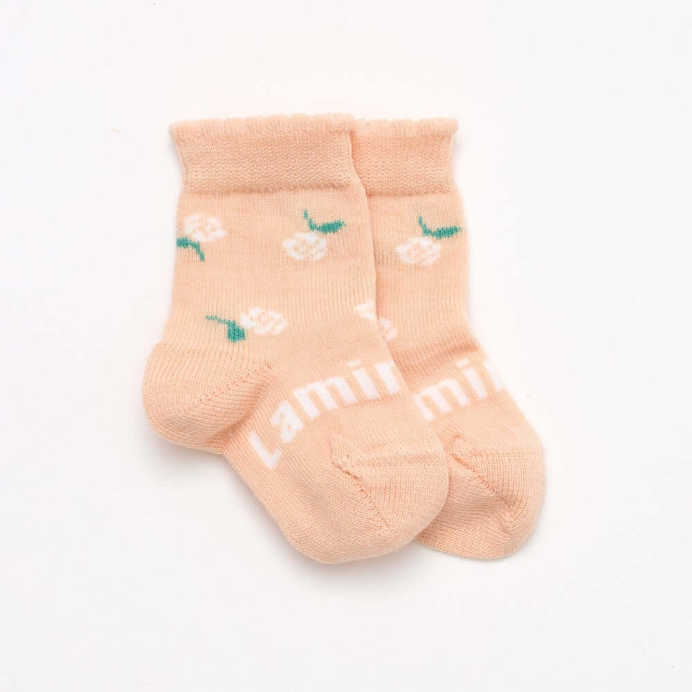 Peach with floral design and a cute frill top merino wool socks for babies NZ