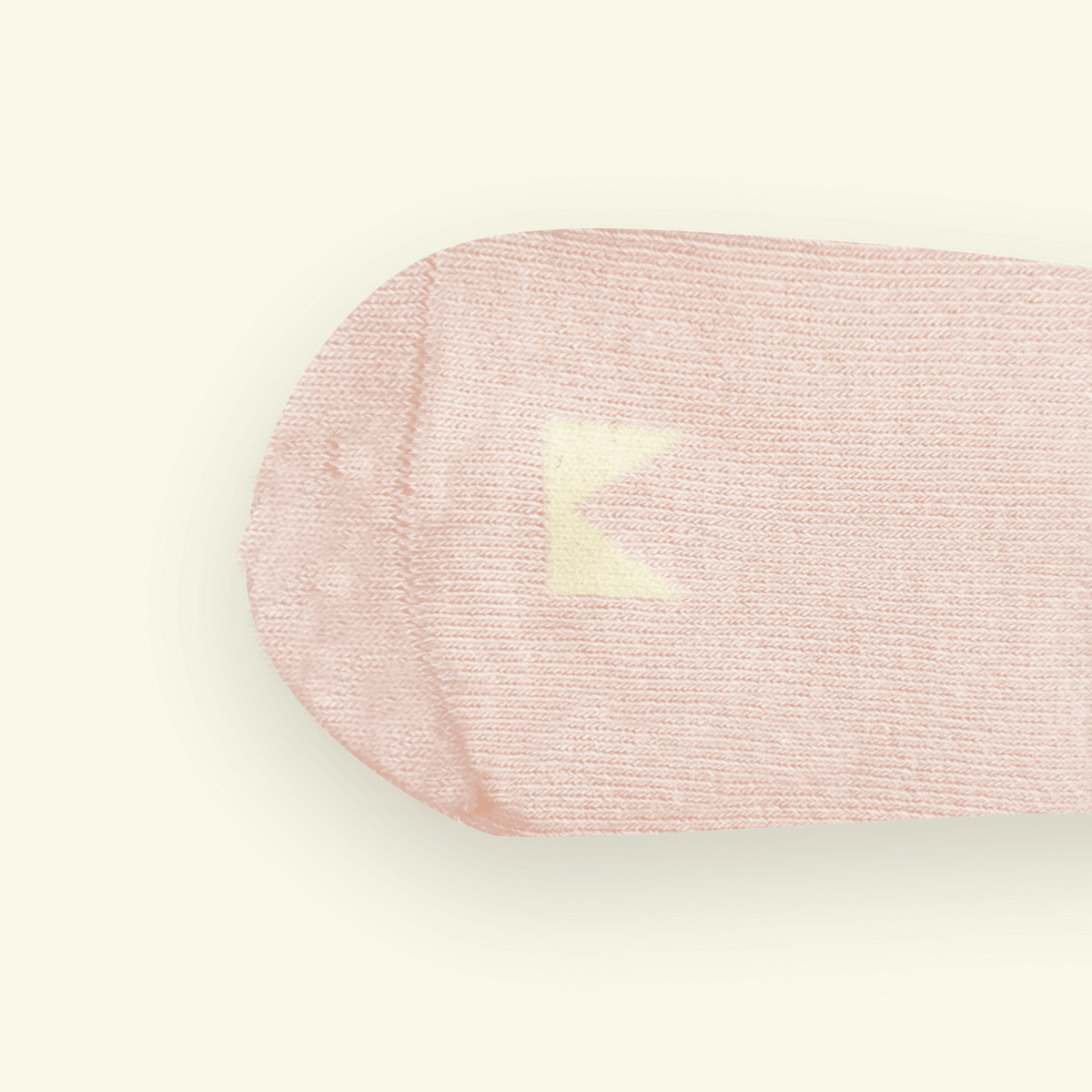 Close-up of Organic Cotton Baby Socks in Blush color with a Mosey logo above the toes.