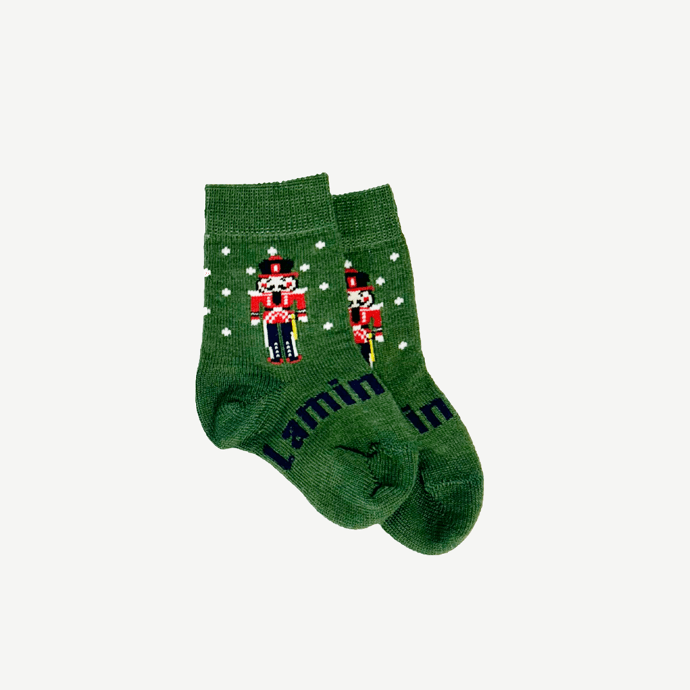 Green socks with white spots with a nutcracker design