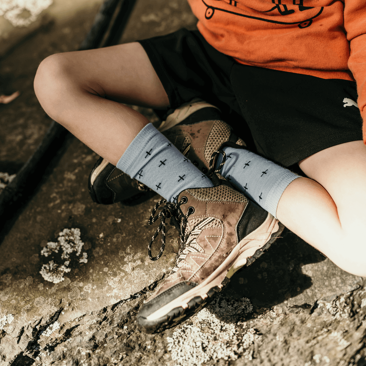 child wearing blue merino socks with navy crosses aus