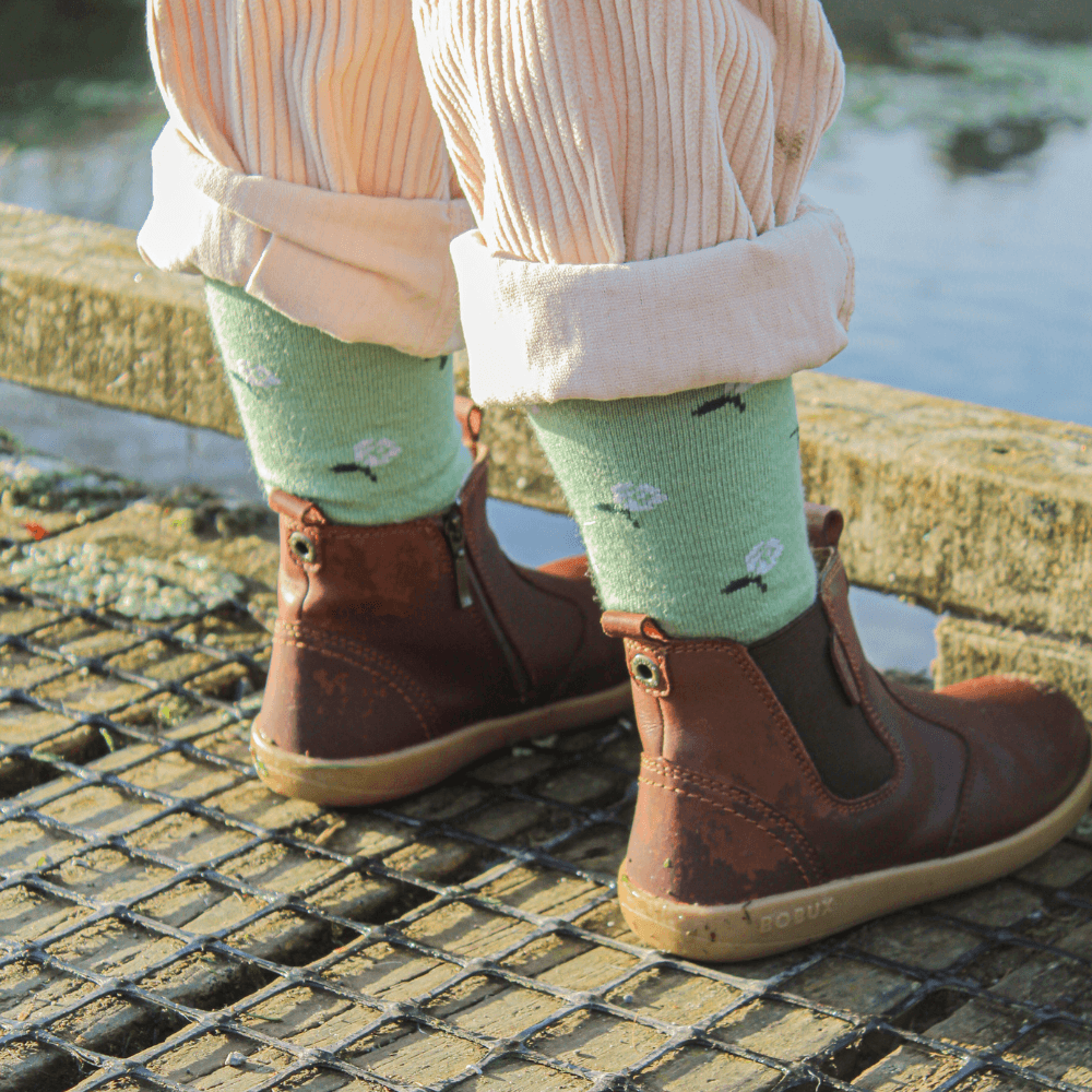 Merino Wool Crew Socks for Child in heather green with light purple flowers and dark green leaves.