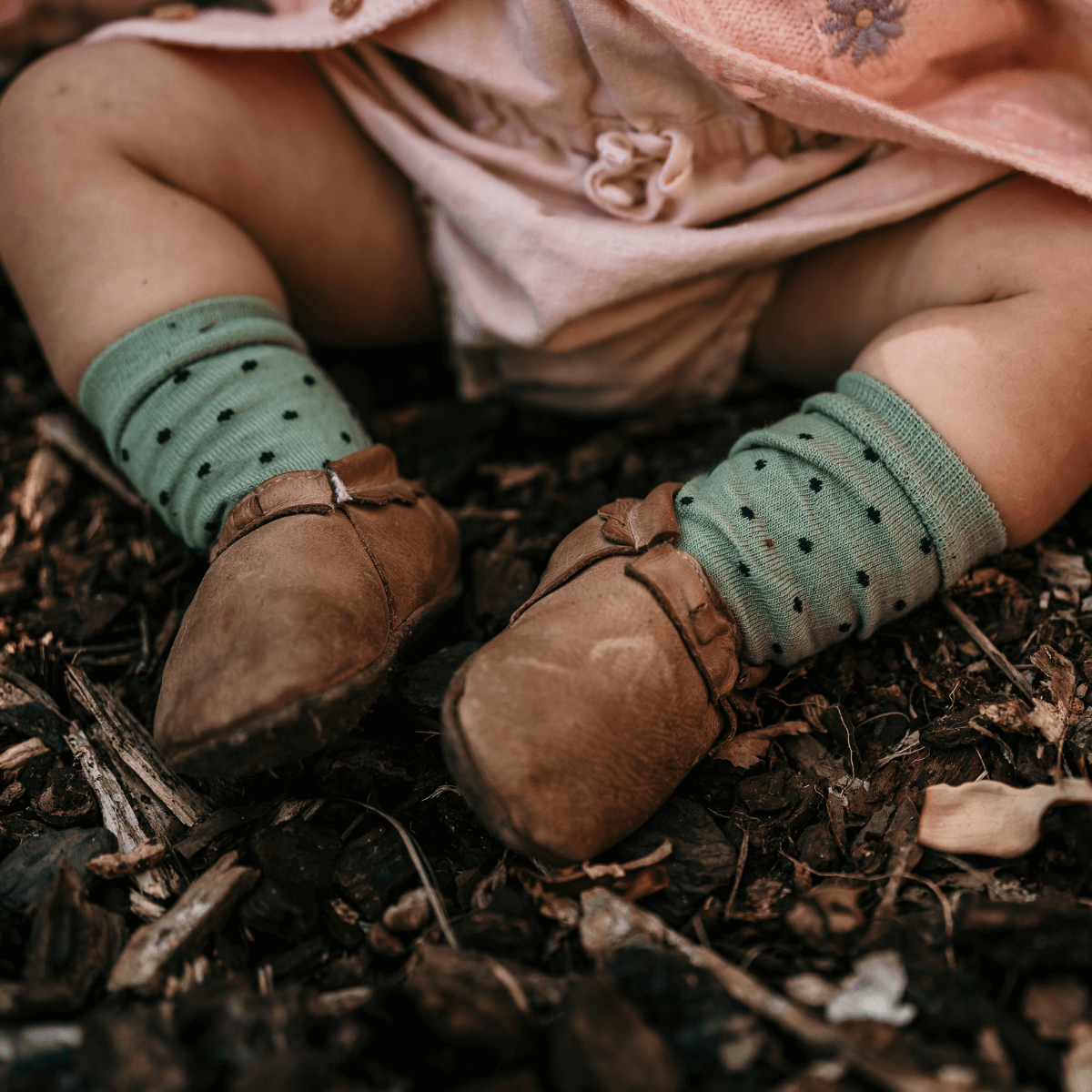 baby wearing merino wool crew socks light green with dark green spots aus