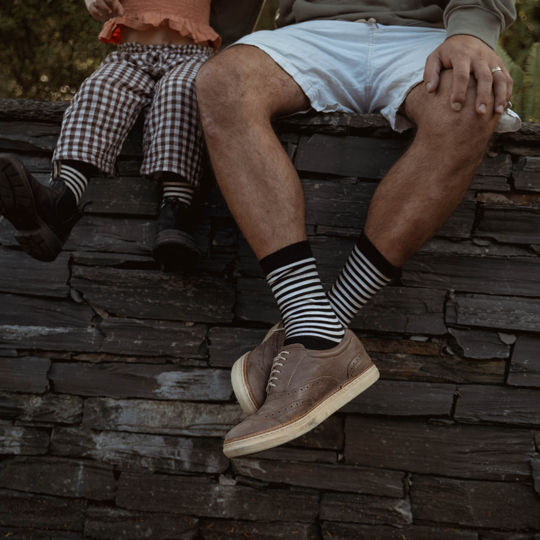 Merino Wool Crew Socks featuring a classic black base with latte colored horizontal stripes.