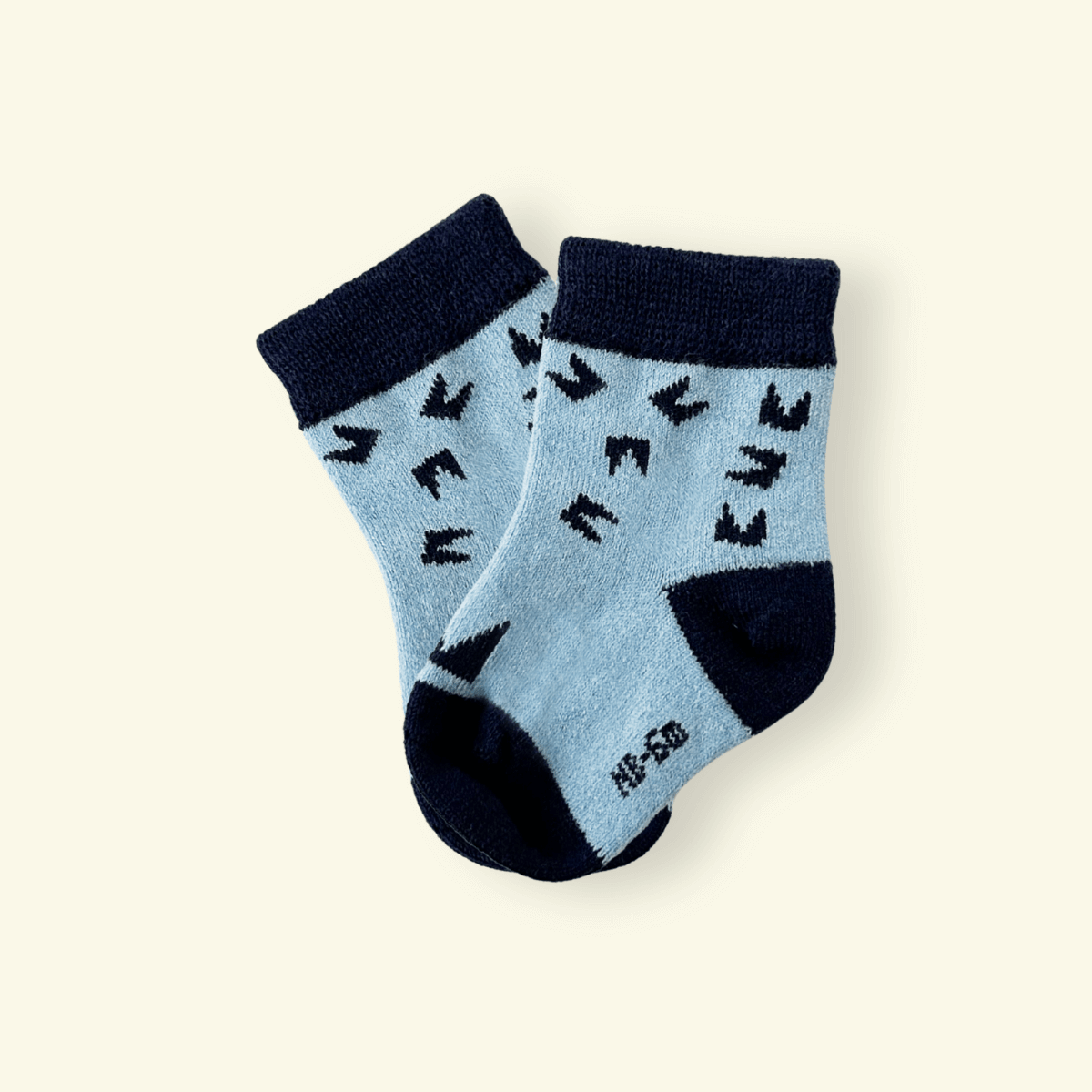 Merino Wool Baby Socks in Night, blue with black pattern, designed for comfort and warmth for infants.