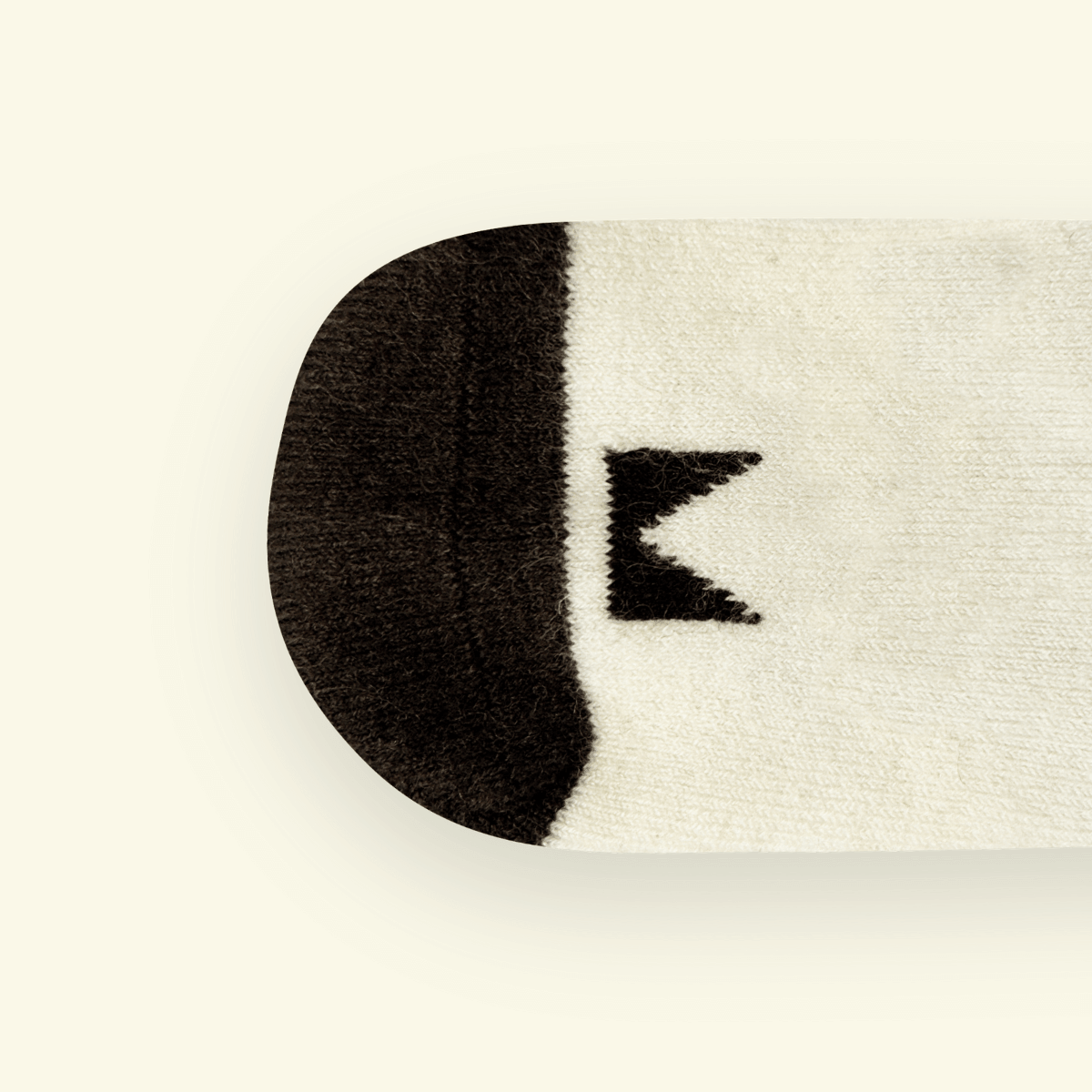 Top view of Merino Wool Baby Socks in Pixel, showcasing the unique logo pattern and cozy fabric design.