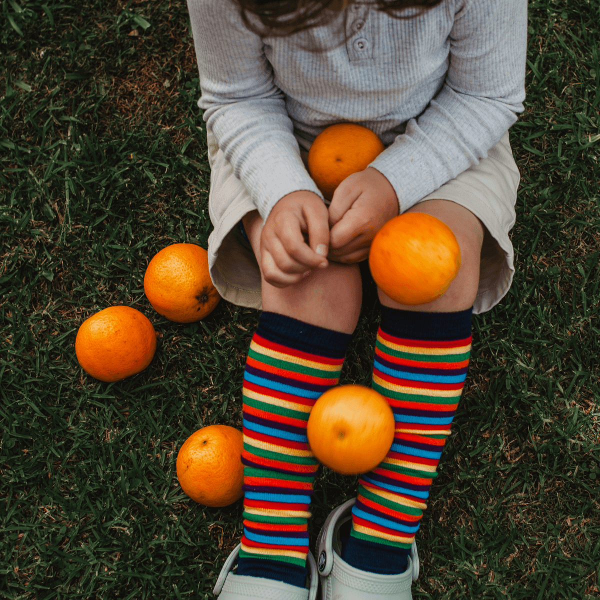 child wearing colourful merino wool knee-high socks au